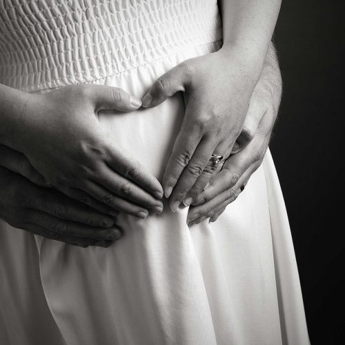 Picture of pregnant mother cradling her precious bump.